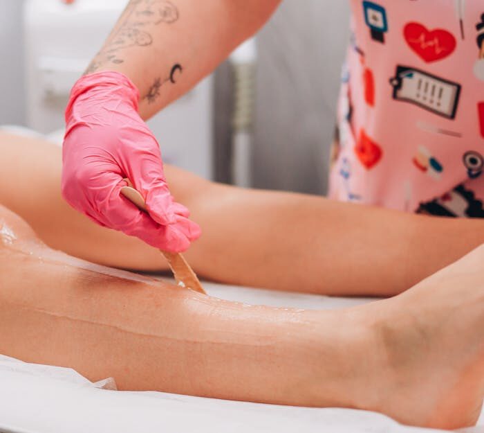 A professional beauty treatment waxing session in a salon setting.
