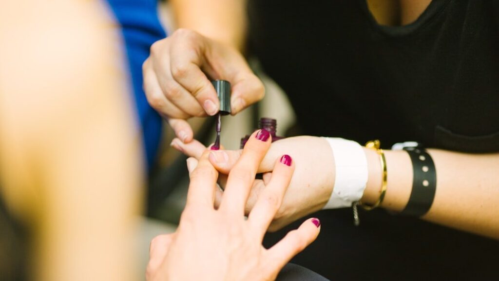 Getting her nails painted